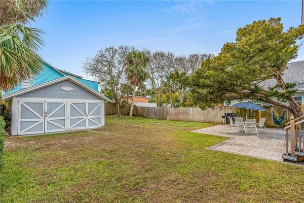 a view of a yard with a house and trees