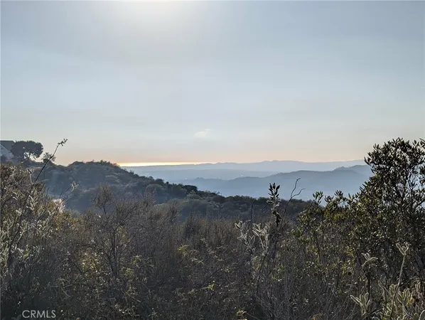 an aerial view of mountain with trees around