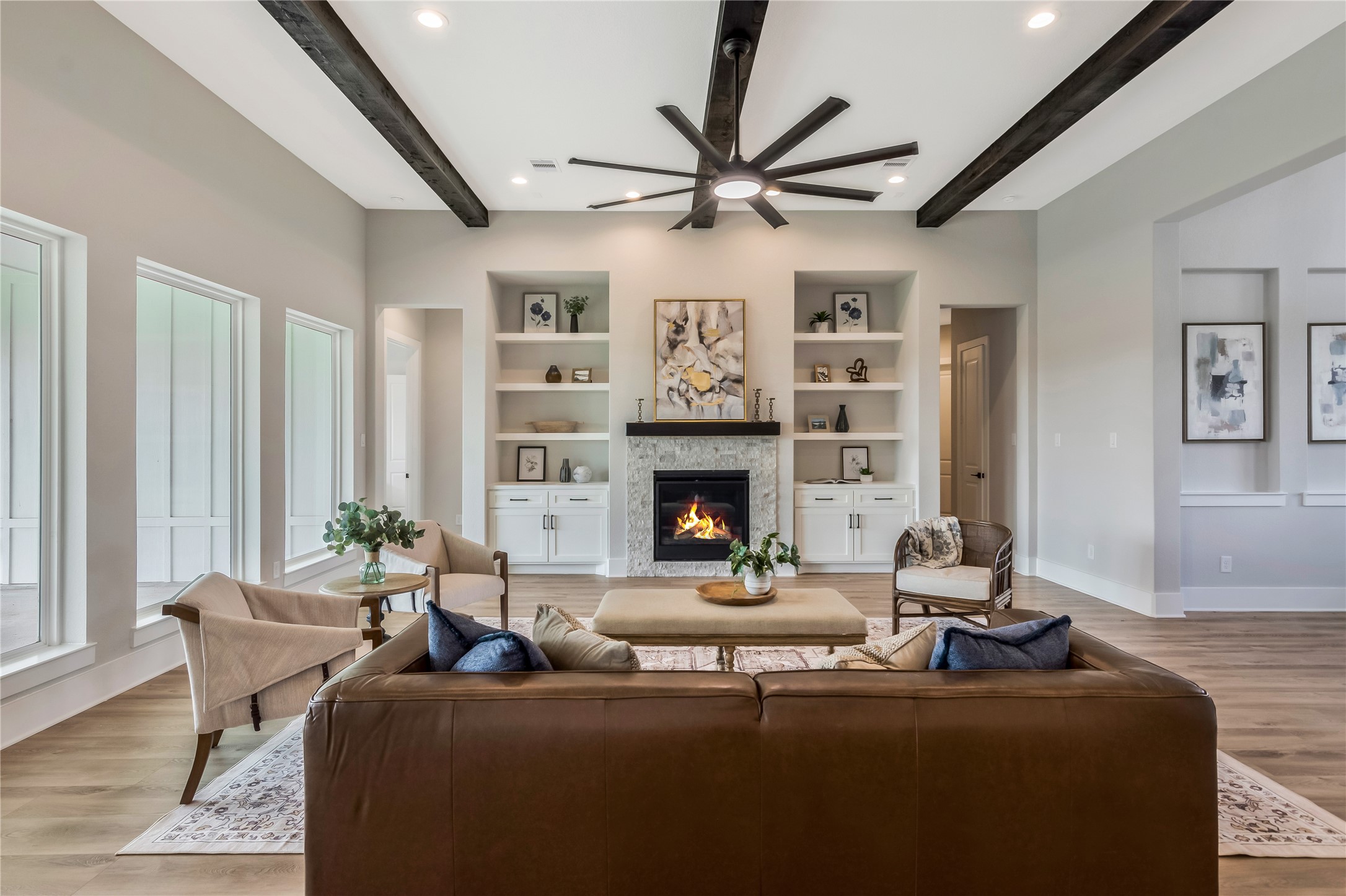 1404 Bluebonnet Ridge Drive Chappell Hill, TX 77426 - Photo 11 of 49 A cozy stone fireplace serves as a focal point, surrounded by built-in shelves
