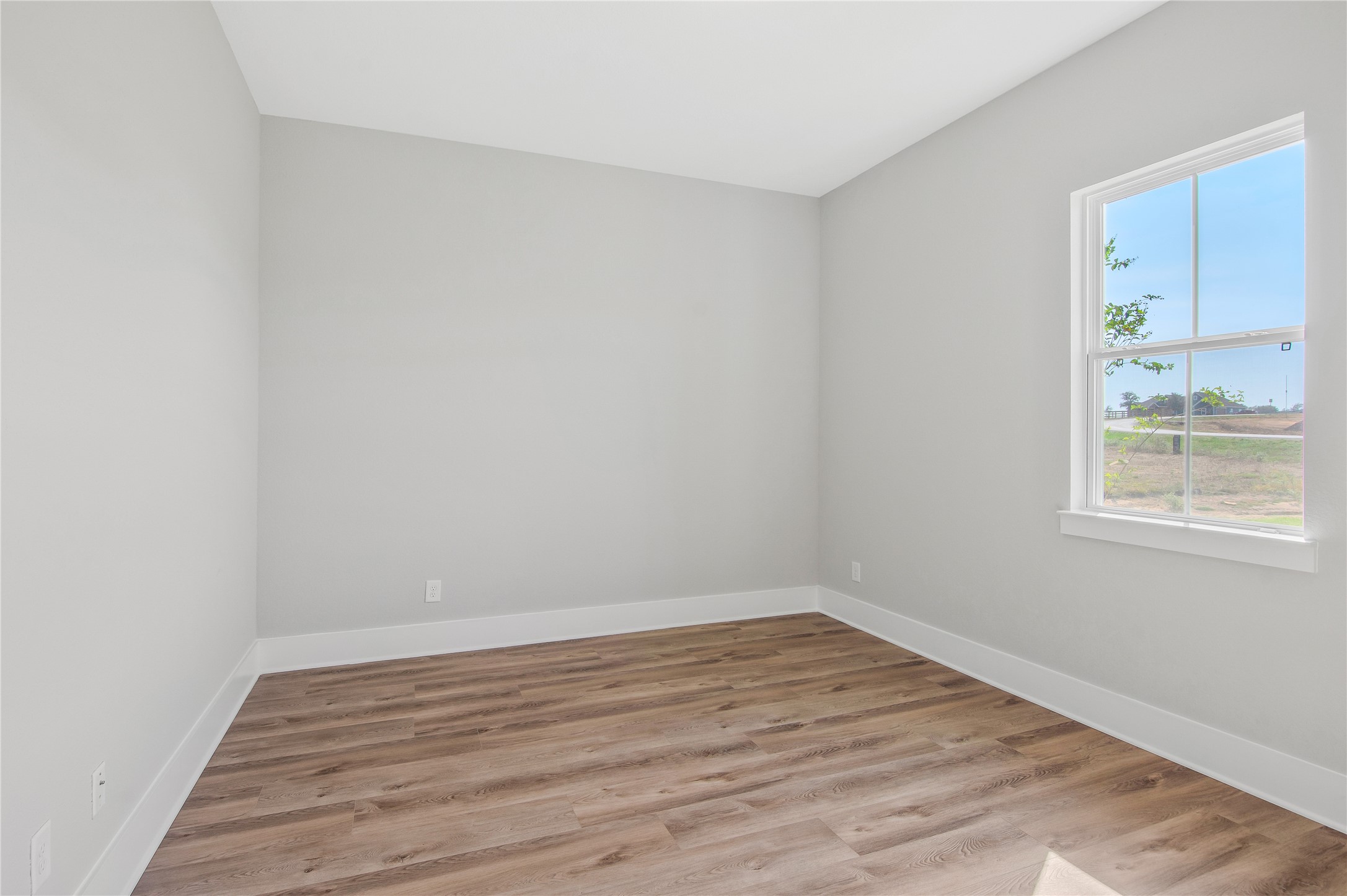 1404 Bluebonnet Ridge Drive Chappell Hill, TX 77426 - Photo 34 of 49 Bright and cozy bedroom with beautiful flooring and a serene view.