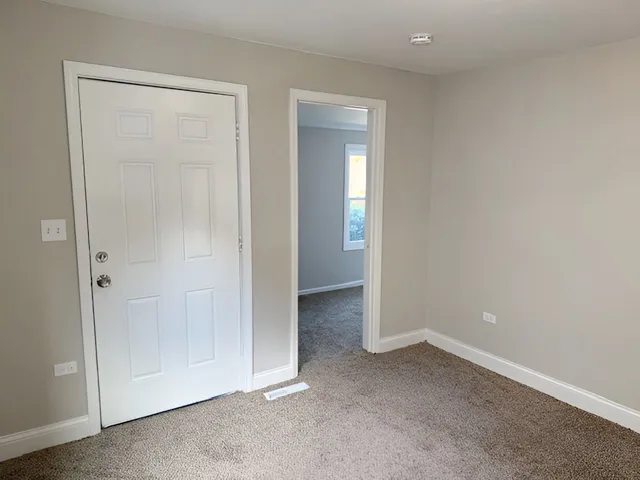 an empty room with closet area