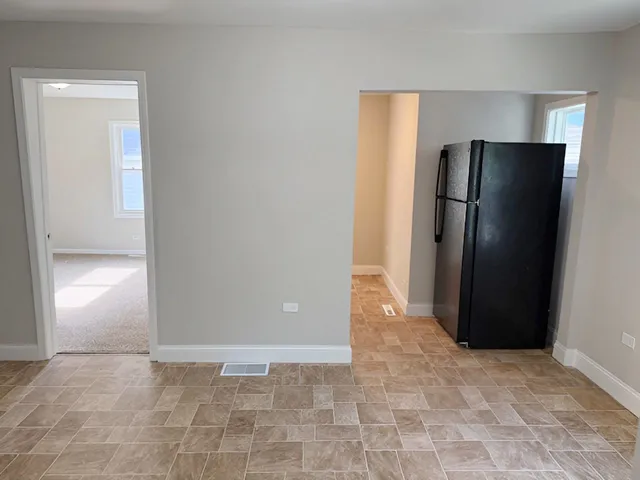 an empty room with closet and a window