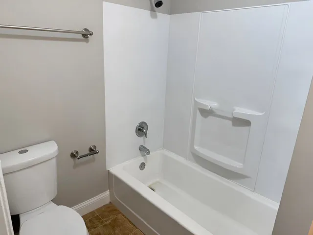 a bathroom with a bathtub and a toilet
