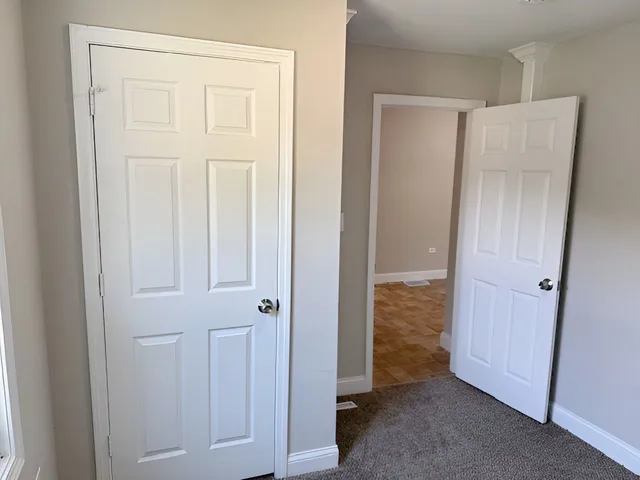 a view of a closet area with an empty room