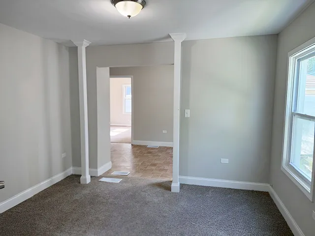 an empty room with windows and closet