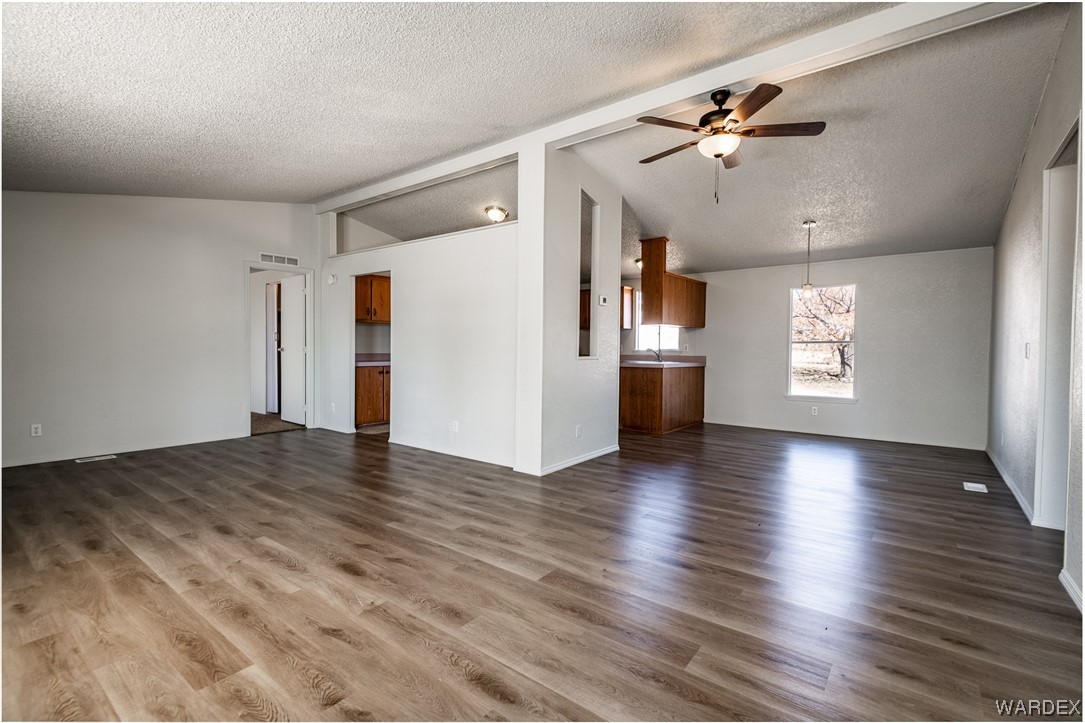 3690 Bagdad Road Golden Valley, AZ 86413 - Photo 6 of 36 a view of an empty room with window and wooden floor