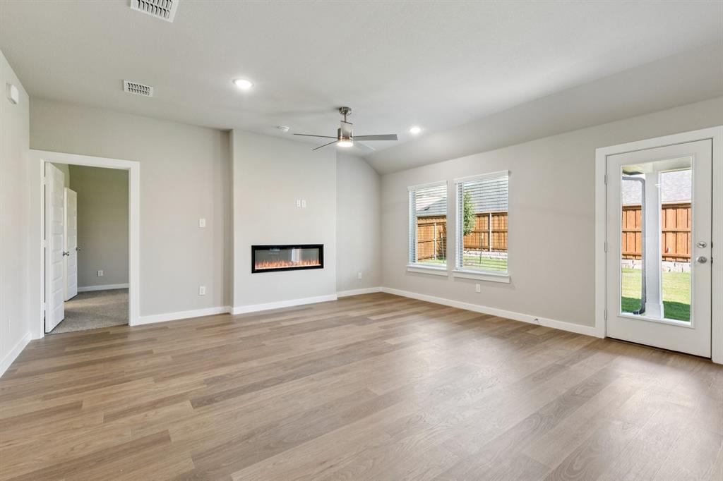 1417 Barbacoa Drive Haslet, TX 76052 - Photo 11 of 32 a view of an empty room with a window and wooden floor