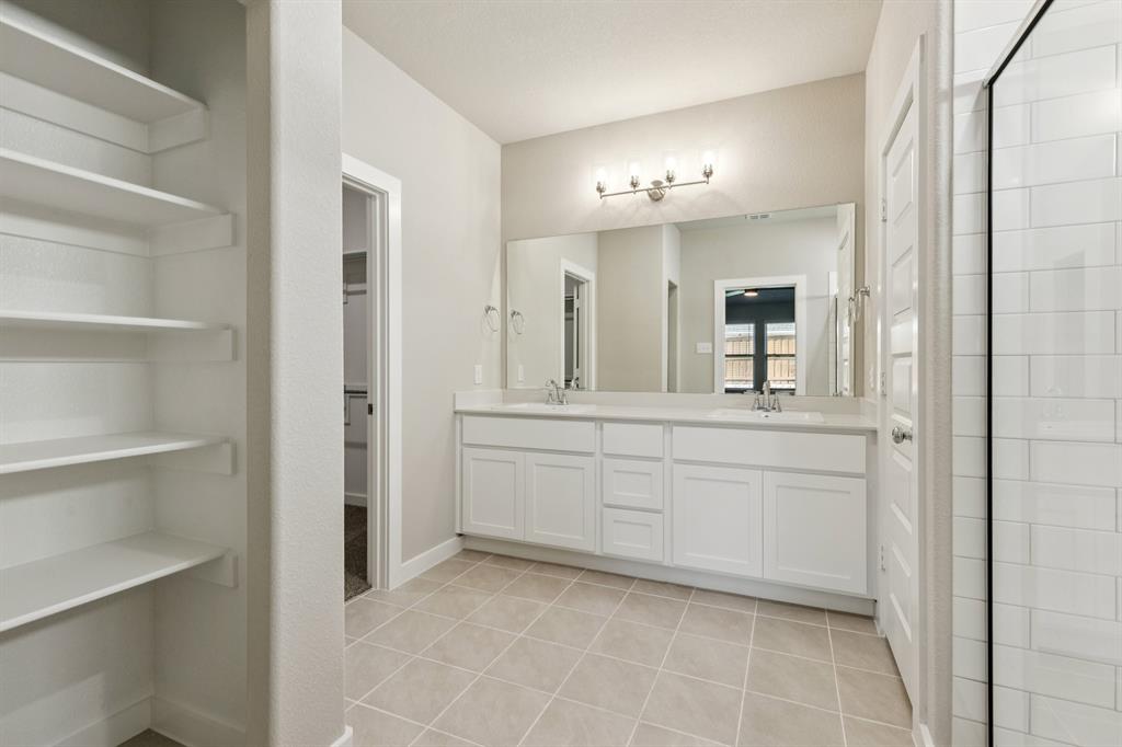 1417 Barbacoa Drive Haslet, TX 76052 - Photo 18 of 32 a bathroom with a sink vanity and a mirror