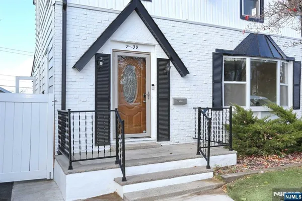a view of a bedroom with wooden floor and a bathroom