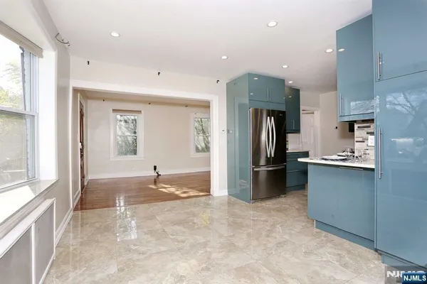 a kitchen with a refrigerator and a sink
