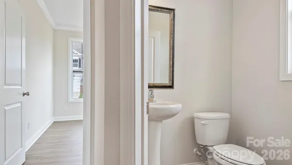 a white toilet sitting next to a bathroom sink