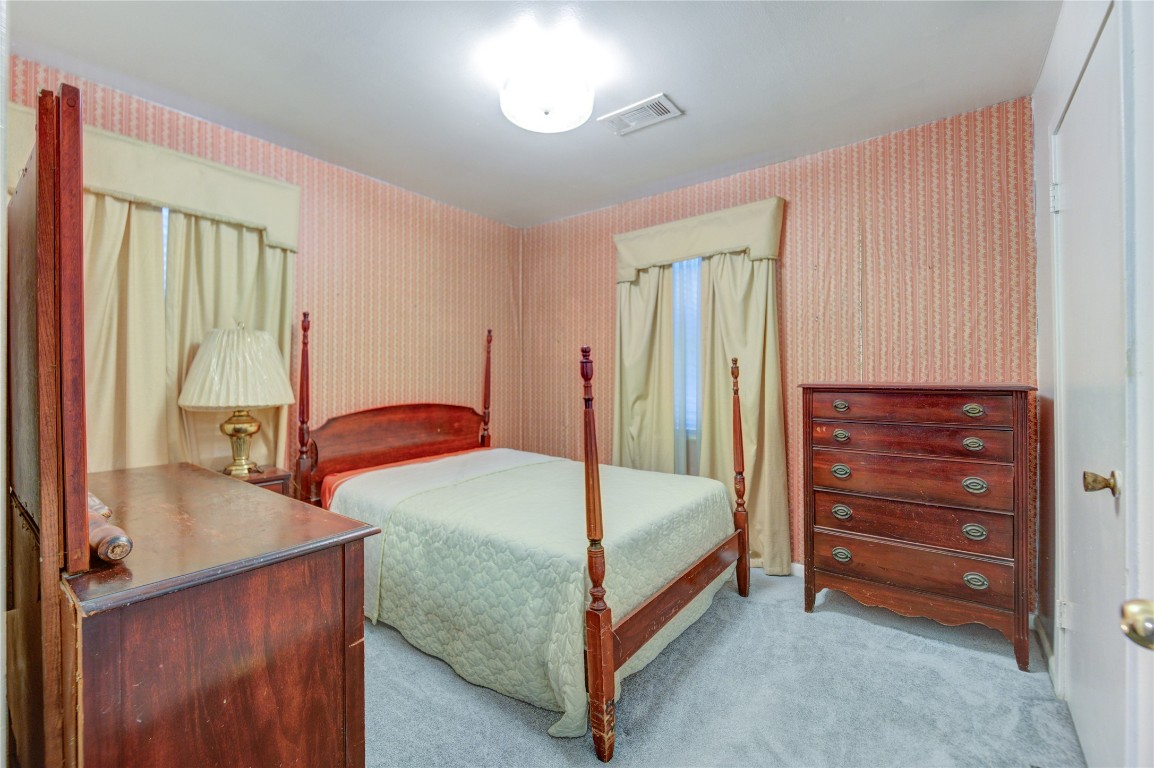 5223 Grace Point Lane Houston, TX 77048 - Photo 13 of 24 a bedroom with a bed and a dresser