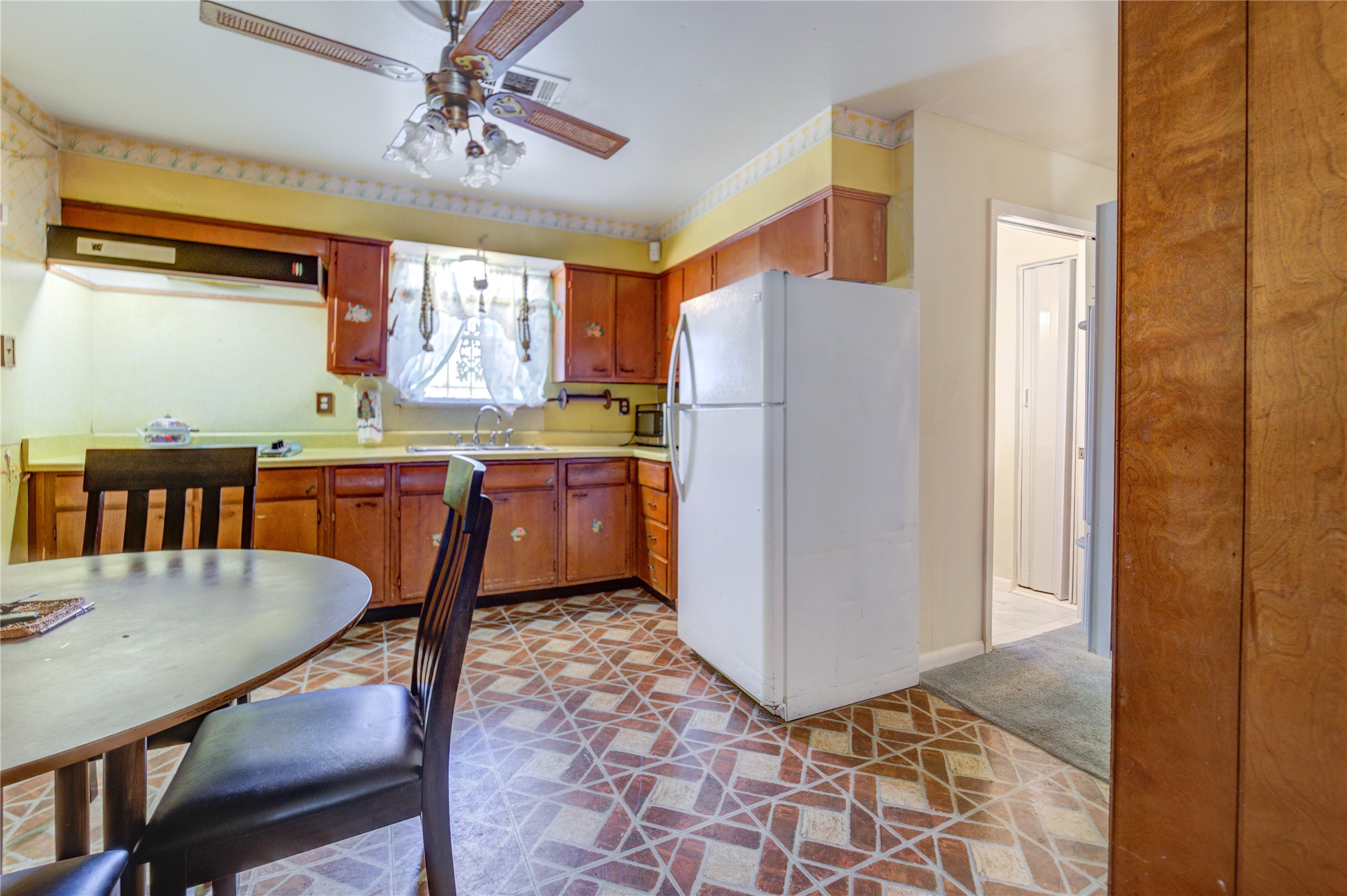 5223 Grace Point Lane Houston, TX 77048 - Photo 17 of 24 a kitchen with a table chairs refrigerator and cabinets