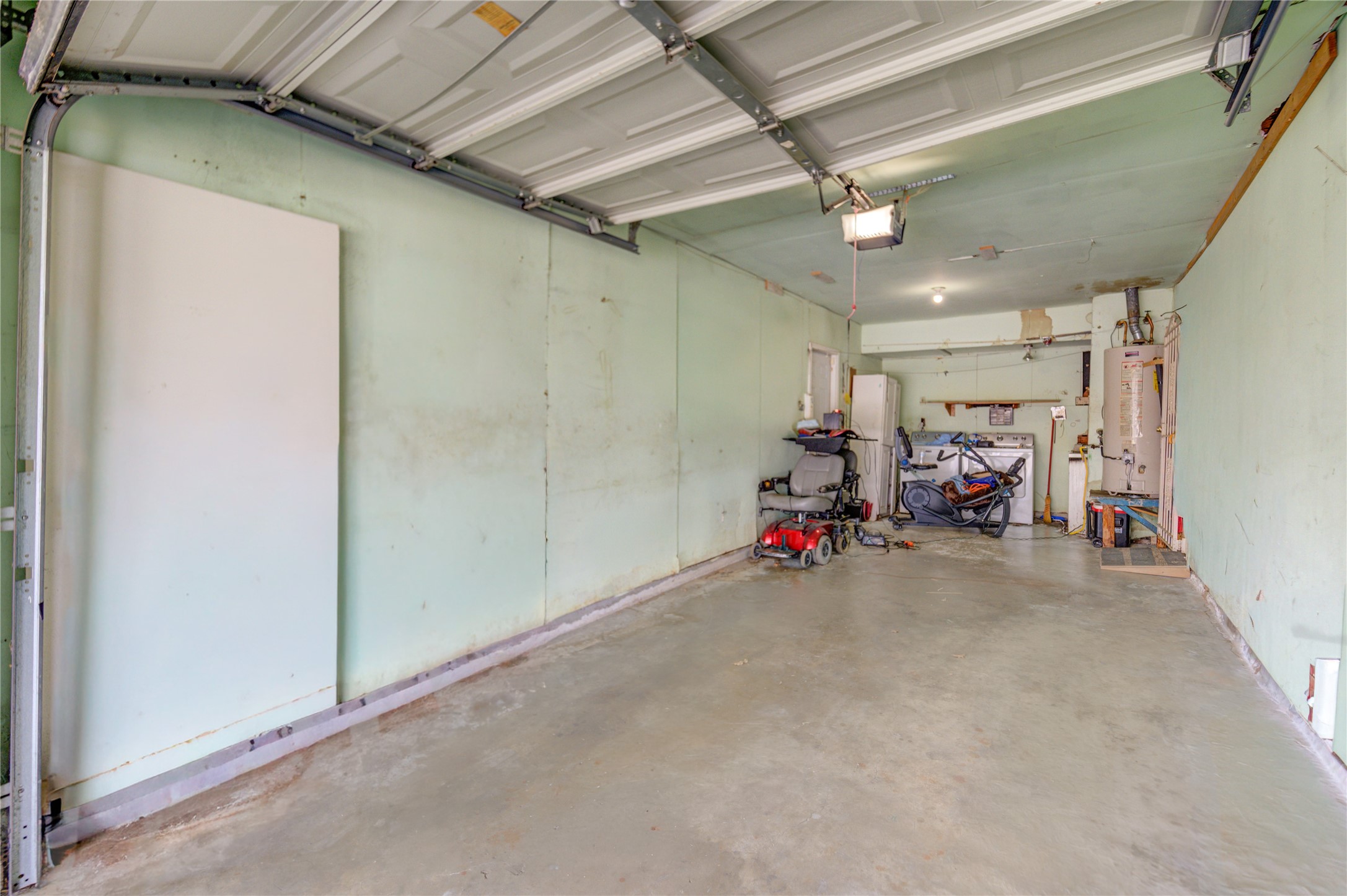 5223 Grace Point Lane Houston, TX 77048 - Photo 18 of 24 a view of a room with dryer and bicycles