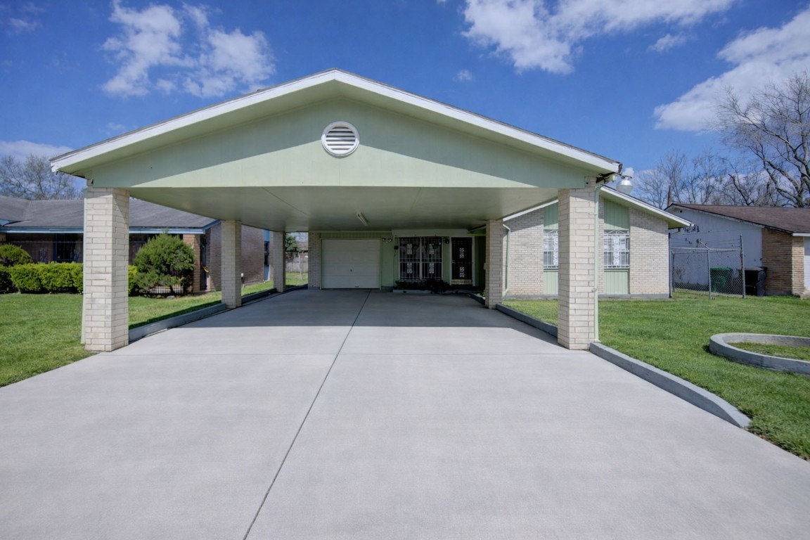 5223 Grace Point Lane Houston, TX 77048 - Photo 2 of 24 a view of a house with a yard and potted plants