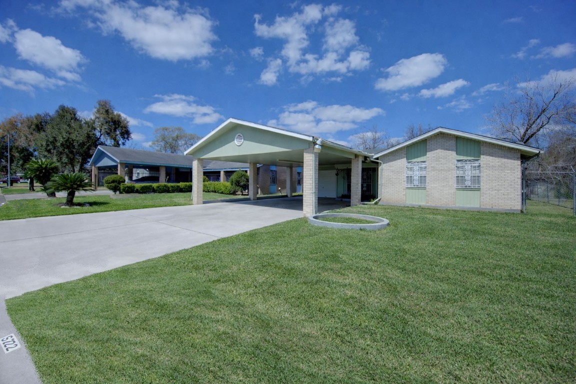 5223 Grace Point Lane Houston, TX 77048 - Photo 4 of 24 a front view of a house with a garden and yard