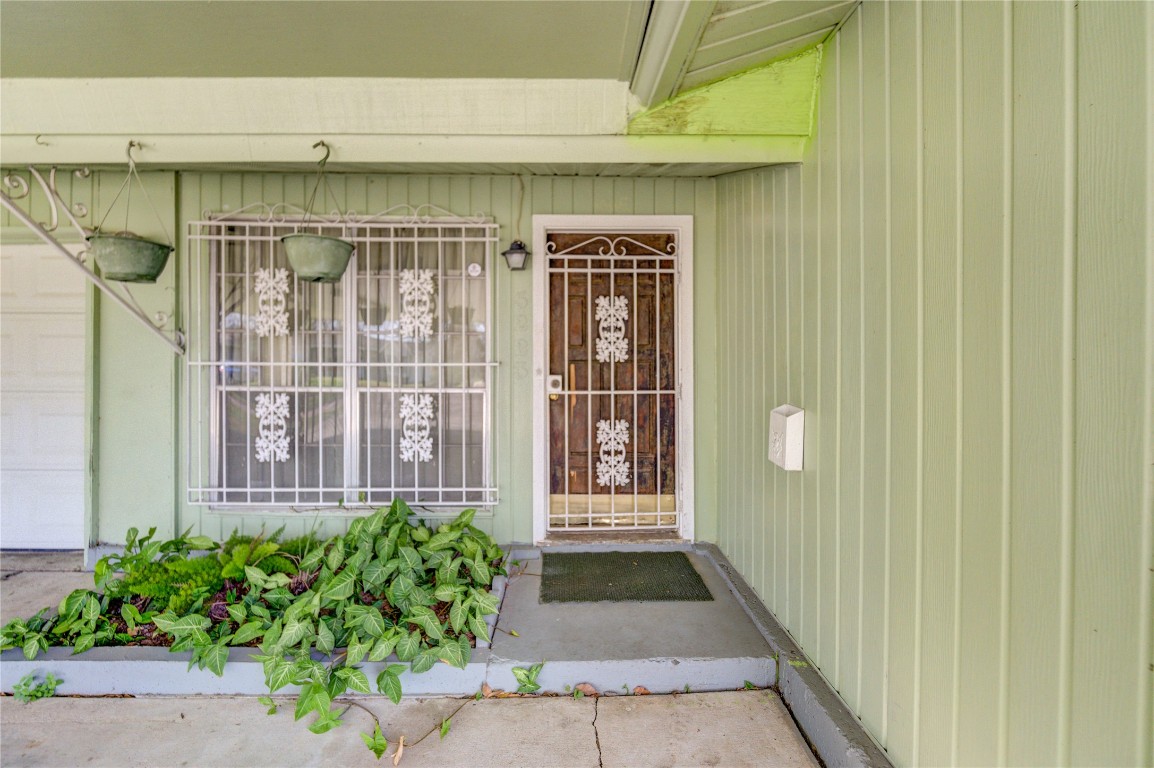 5223 Grace Point Lane Houston, TX 77048 - Photo 6 of 24 a view of a door with a potted plant and a window