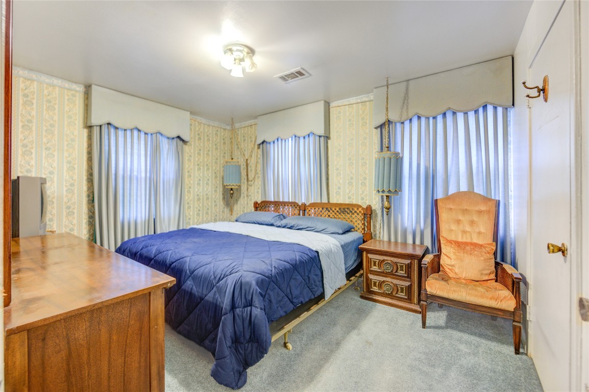 5223 Grace Point Lane Houston, TX 77048 - Photo 10 of 24 a spacious bedroom with a bed and a chandelier