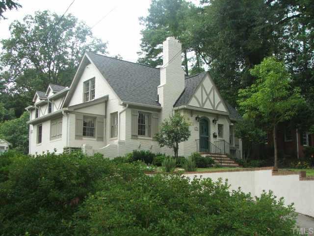 1505 Pineview Street Raleigh, NC 27608 - Photo 1 of 1 a view of a white house next to a yard with plants and trees