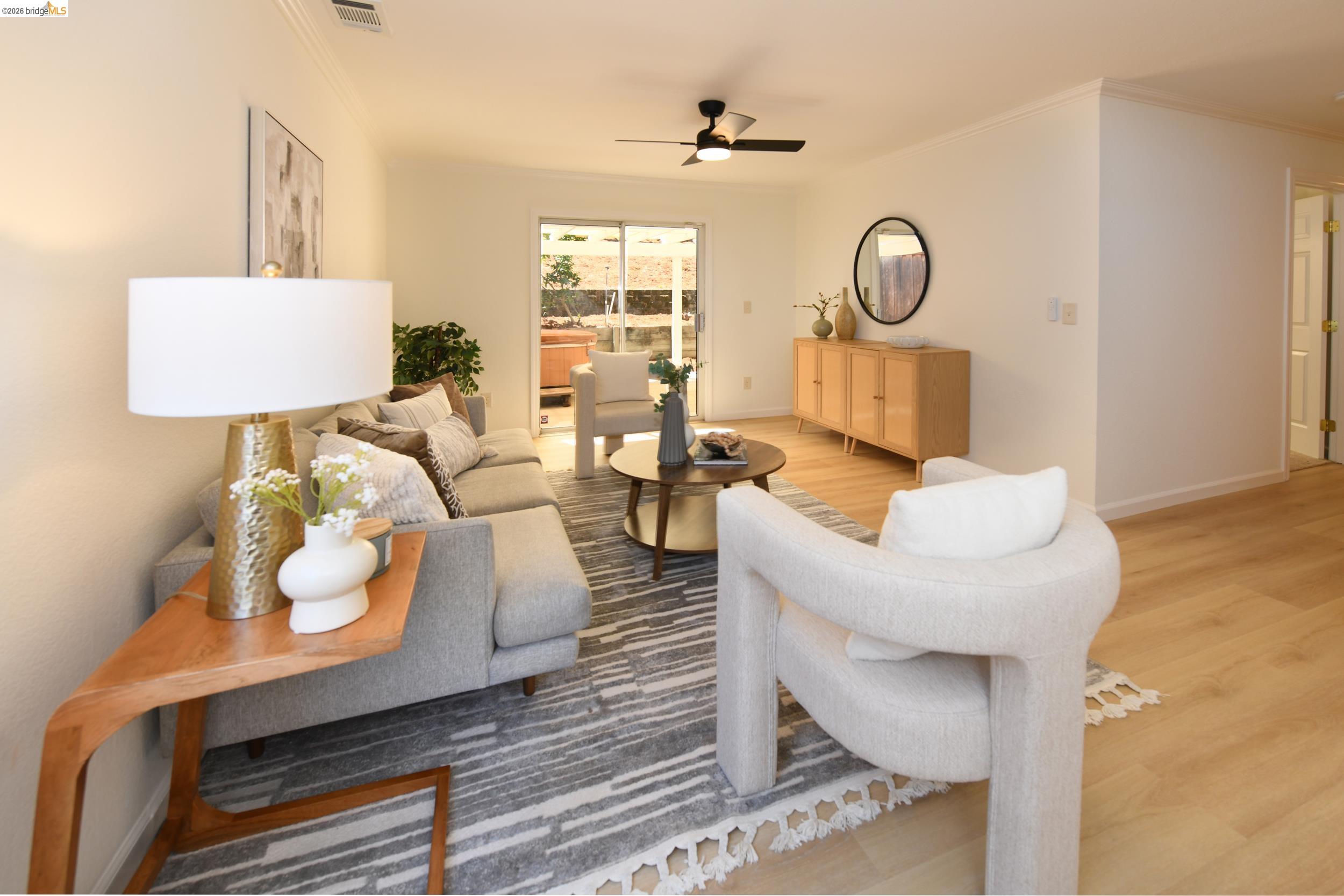 512 Burdick Drive Bay Point, CA 94565 - Photo 23 of 50 Open-concept living area featuring light wood-finish flooring, a contemporary ceiling fan, and sliding glass doors providing access to outdoor space
