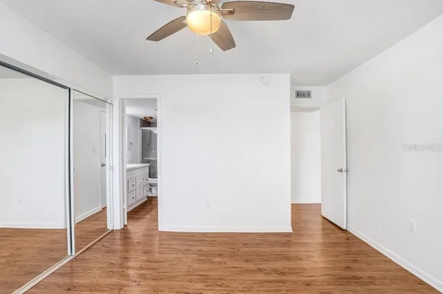 a view of an empty room and wooden floor