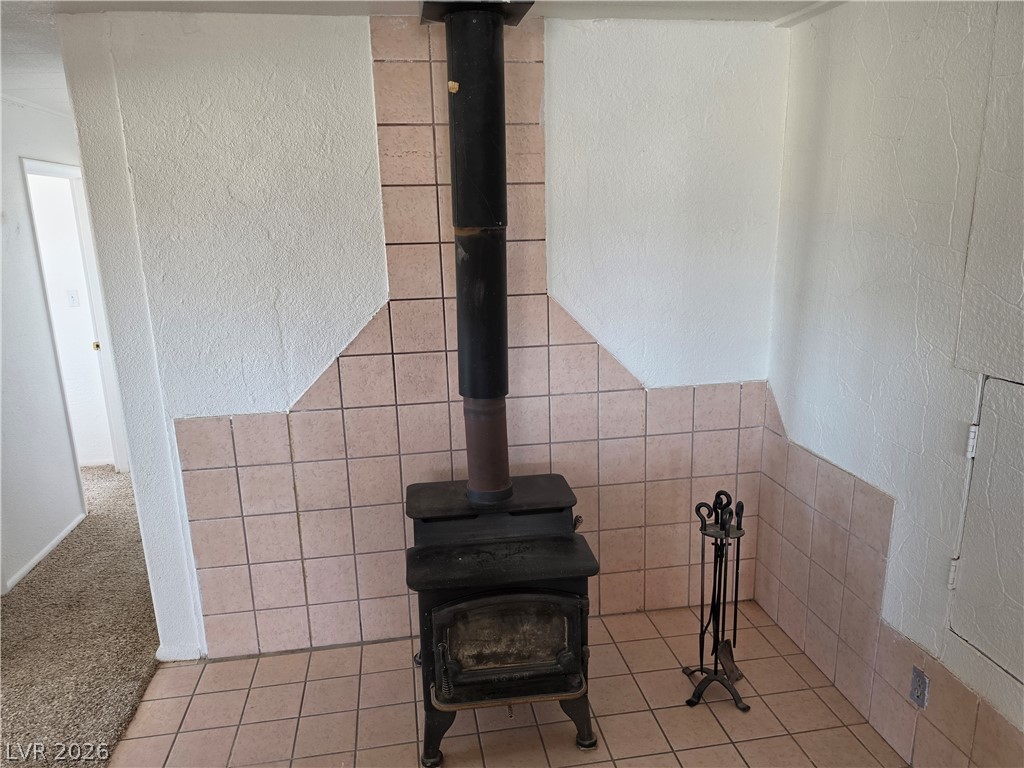 2930 Frehner Ranch Road Pioche, NV 89043 - Photo 31 of 39 A cozy wood-burning stove with tile surround provides a warm gathering space.
