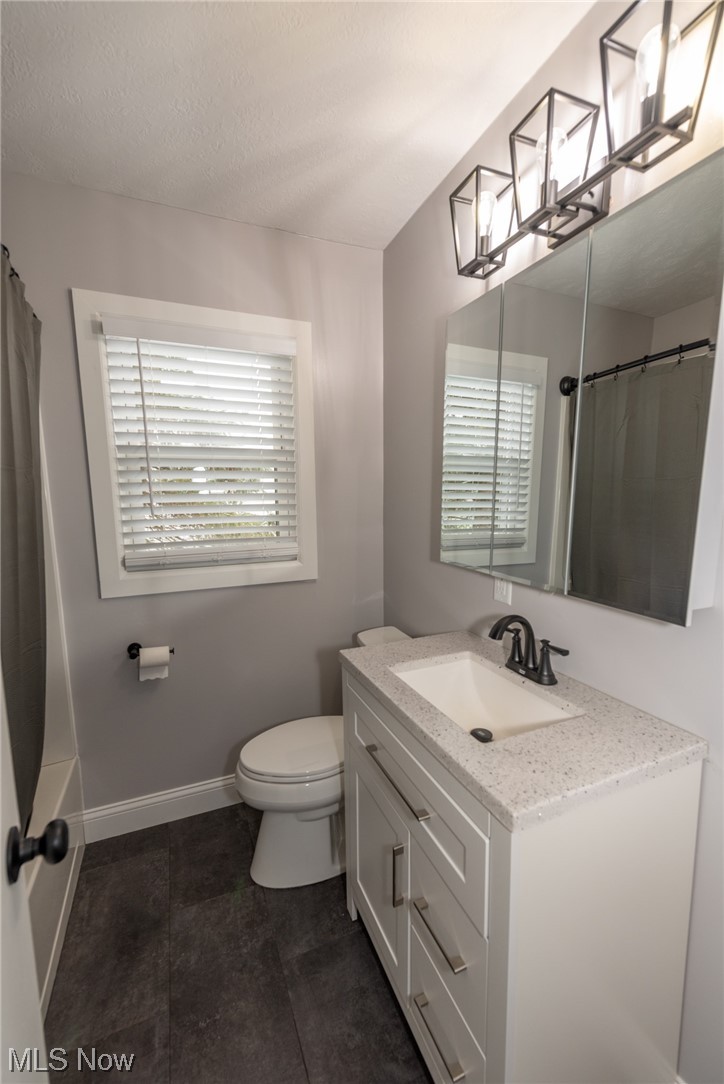 805 Gougler Road Akron, OH 44319 - Photo 13 of 21 Bathroom with tile flooring, oversized vanity, a wealth of natural light, and toilet