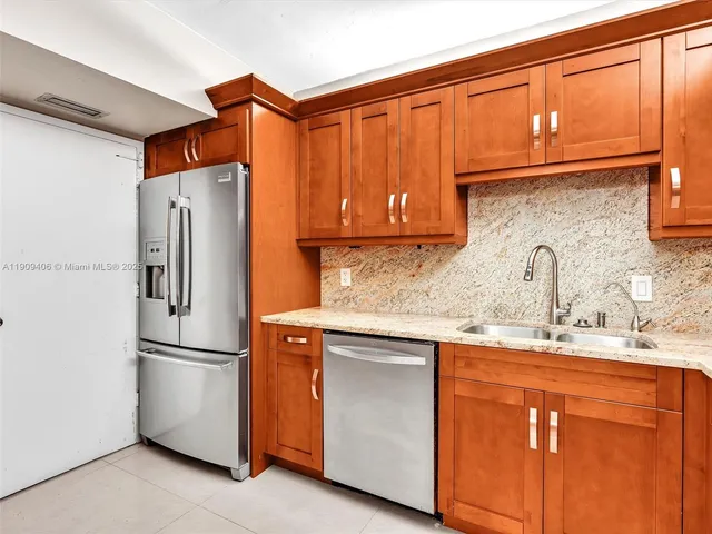 a kitchen with stainless steel appliances granite countertop a stove microwave and sink