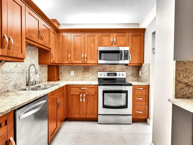 a view of a room with a large window and wooden floor
