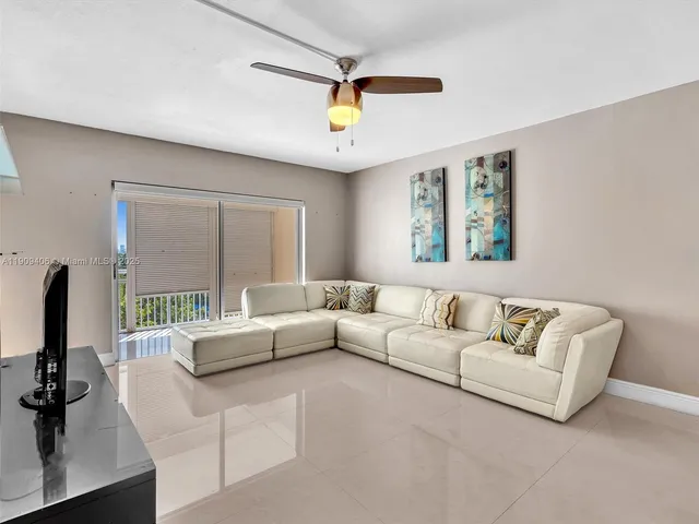 a living room with furniture and kitchen view