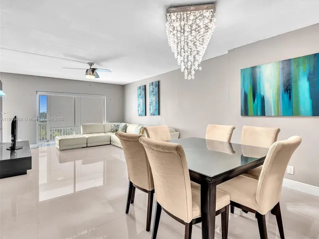 a view of a dining room with furniture and chandelier
