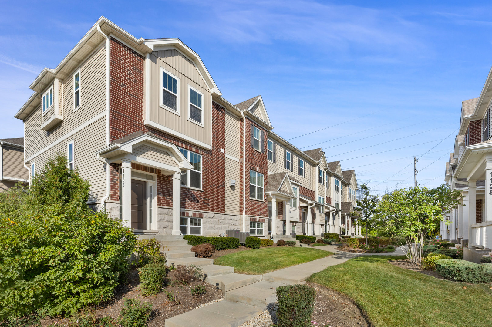 a front view of a building with a garden