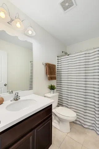 a bathroom with a sink a toilet and mirror