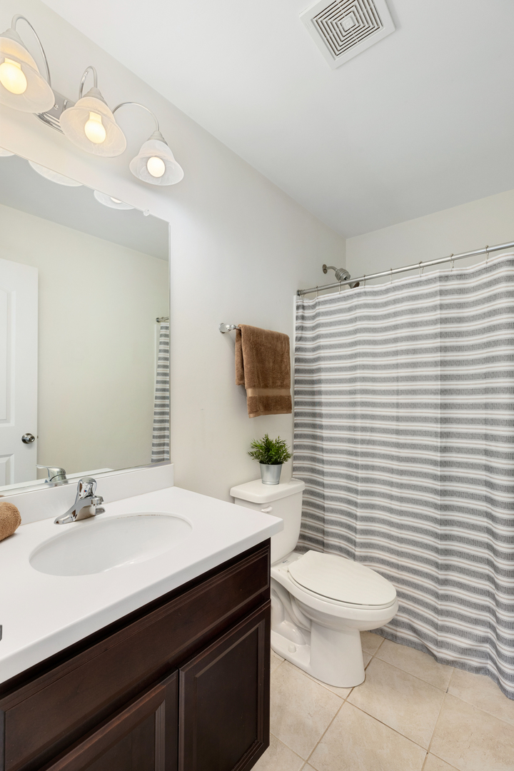 1108 Evergreen Avenue Des Plaines, IL 60016 - Photo 13 of 20 a bathroom with a sink a toilet and mirror
