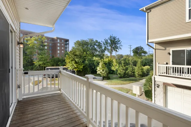 a view of a balcony with wooden floor and fence