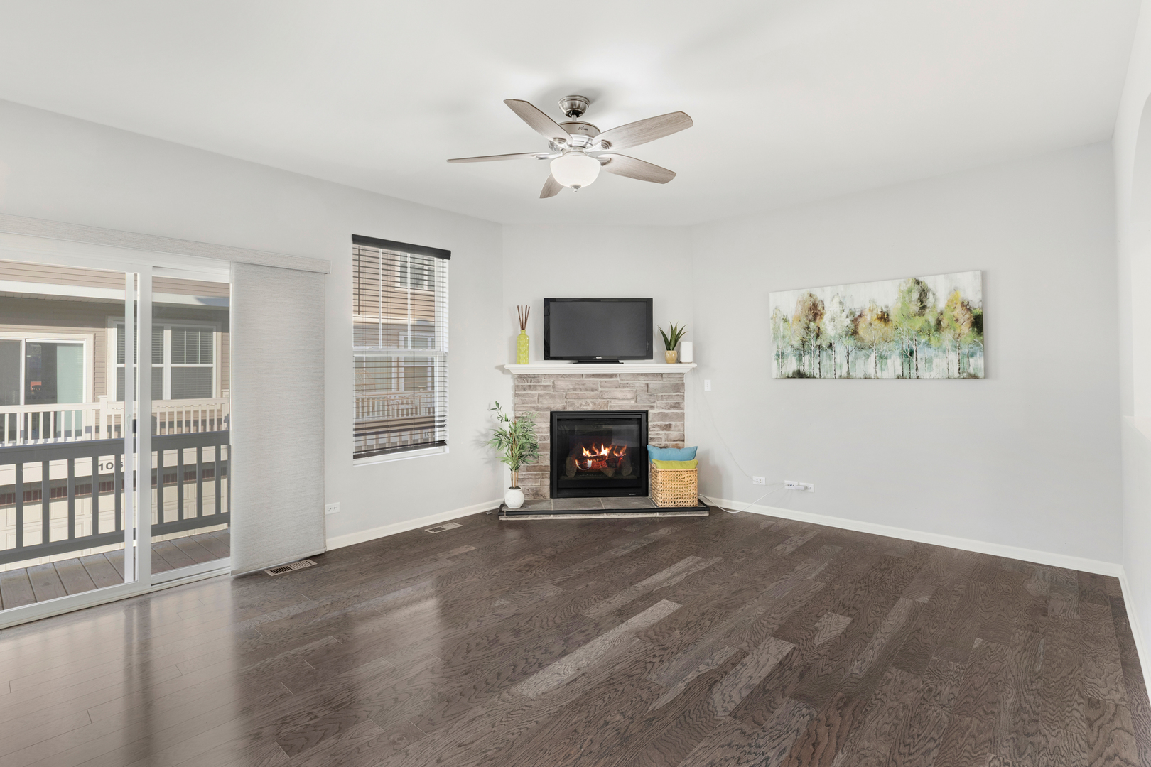 1108 Evergreen Avenue Des Plaines, IL 60016 - Photo 6 of 20 a view of a livingroom with a fireplace a ceiling fan and windows