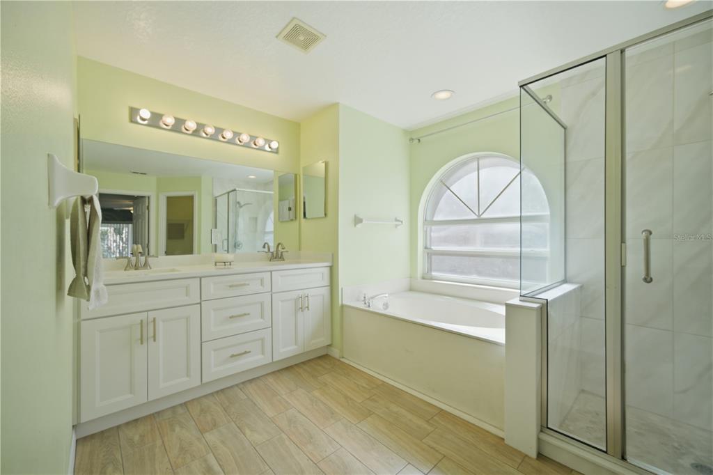 632 Blenheim Loop Winter Springs, FL 32708 - Photo 11 of 55 a spacious bathroom with a mirror a sink and a shower