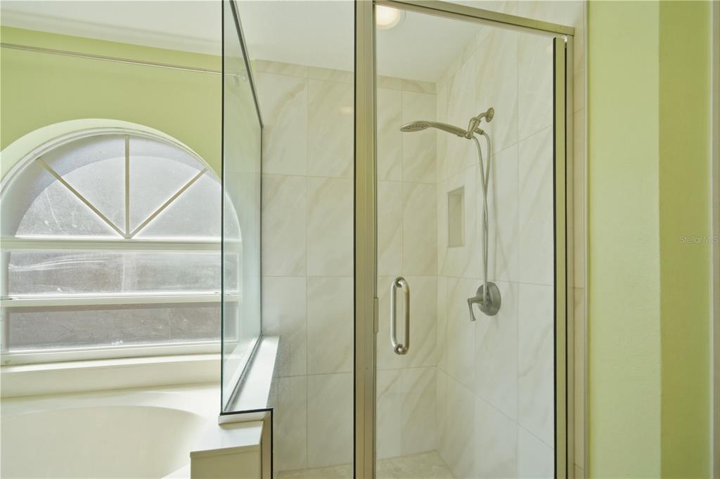 632 Blenheim Loop Winter Springs, FL 32708 - Photo 12 of 55 a bathroom with a glass door shower and a mirror