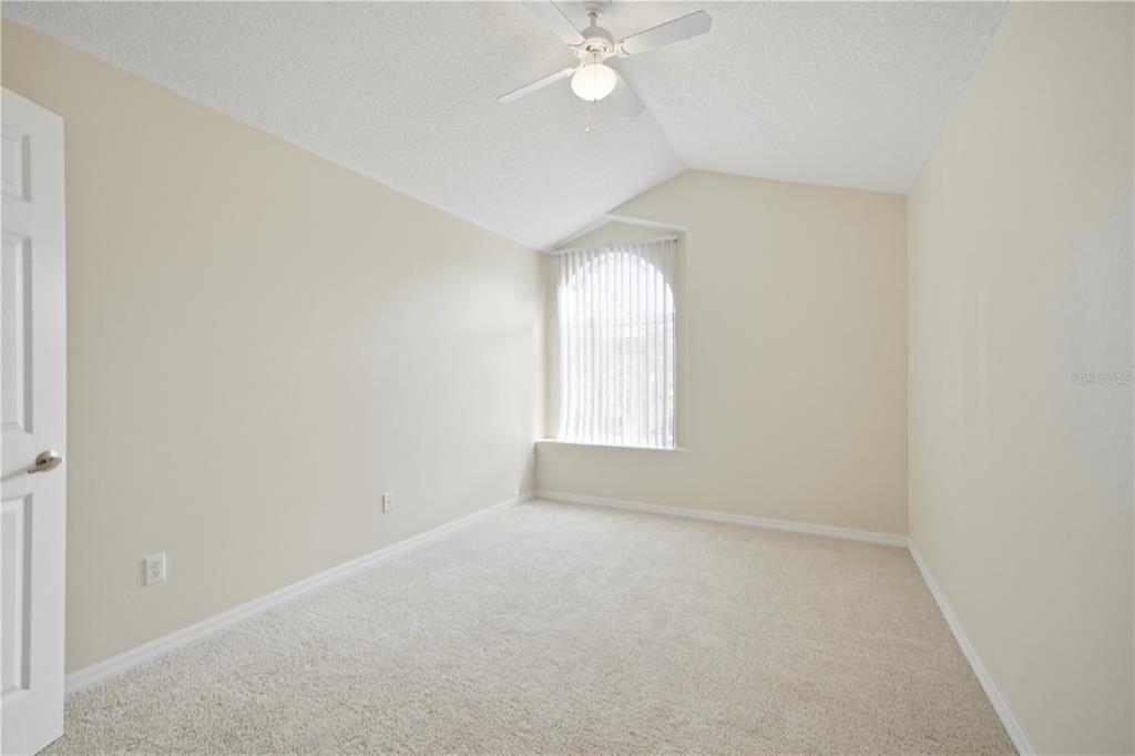 632 Blenheim Loop Winter Springs, FL 32708 - Photo 17 of 55 an empty room with a chandelier fan and windows