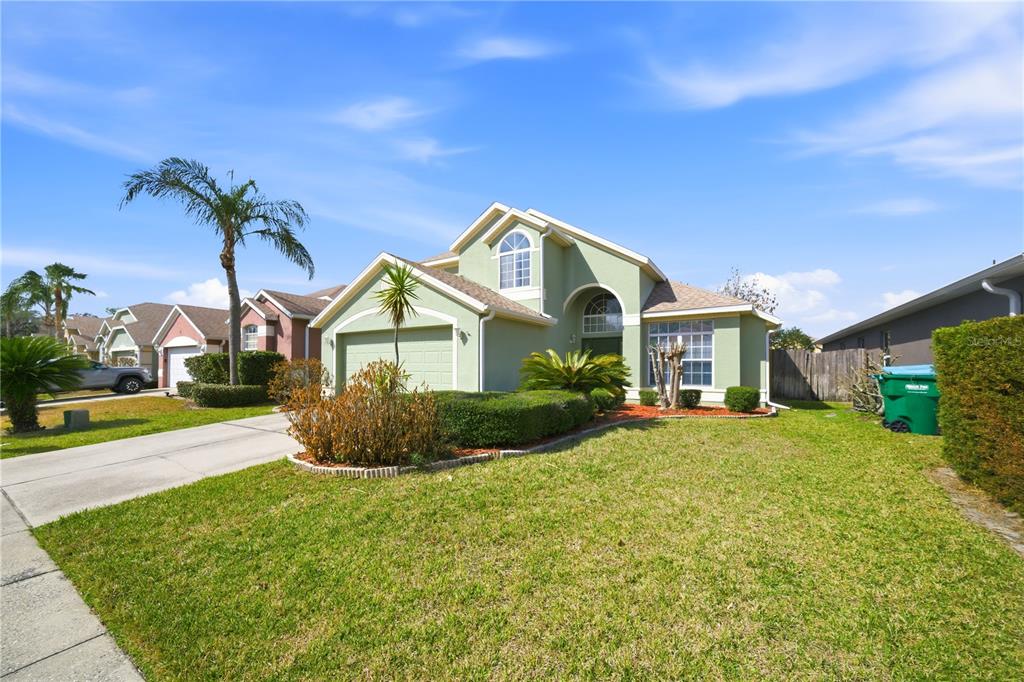 632 Blenheim Loop Winter Springs, FL 32708 - Photo 2 of 55 a front view of a house with a yard and potted plants