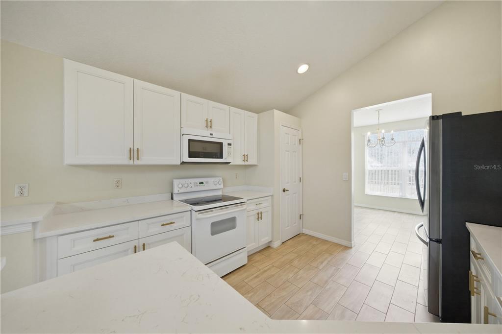 632 Blenheim Loop Winter Springs, FL 32708 - Photo 29 of 55 a kitchen with stainless steel appliances white cabinets and a refrigerator