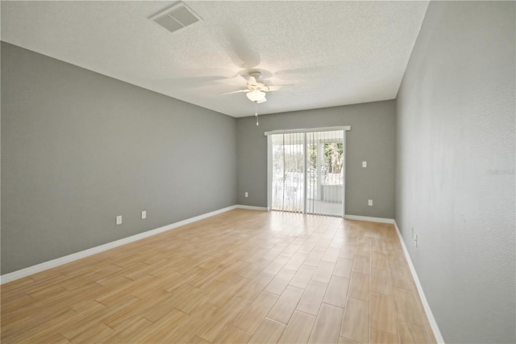 632 Blenheim Loop Winter Springs, FL 32708 - Photo 9 of 55 wooden floor in an empty room with a window