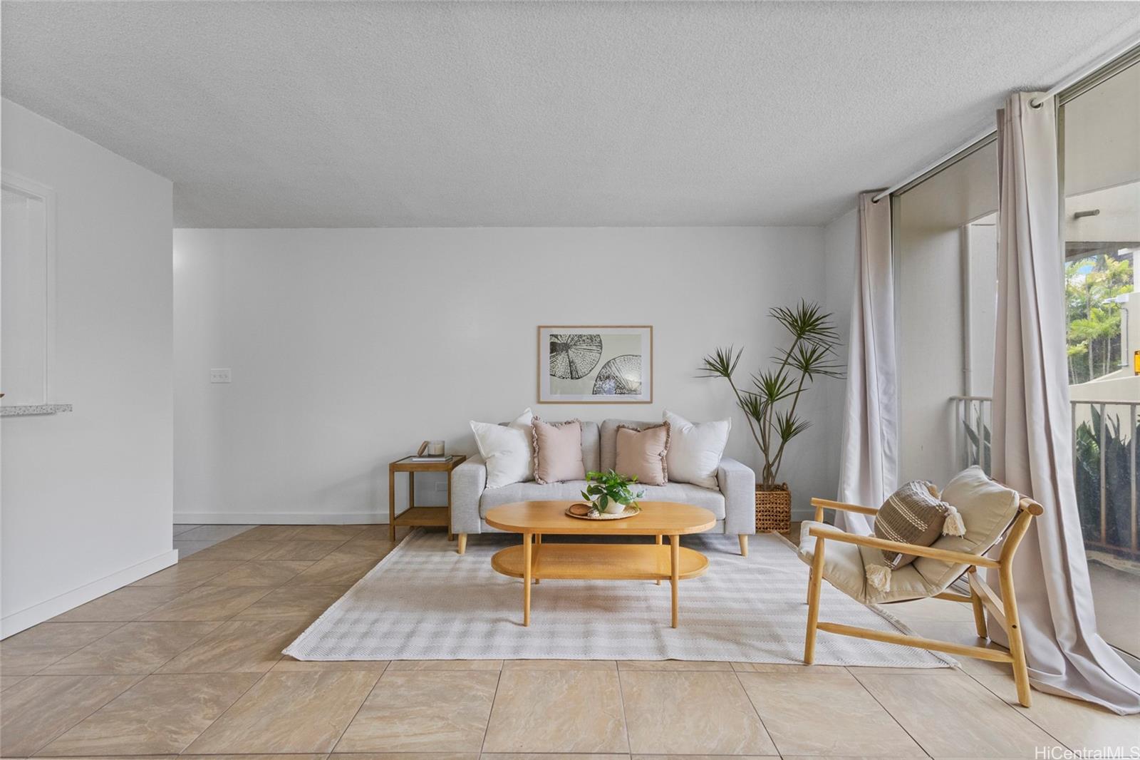 98-1038 Moanalua Road, Unit 7/101 Aiea, HI 96701 - Photo 1 of 1 a living room with furniture and a potted plant
