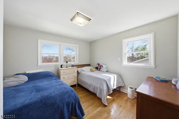 a bedroom with two beds and a window