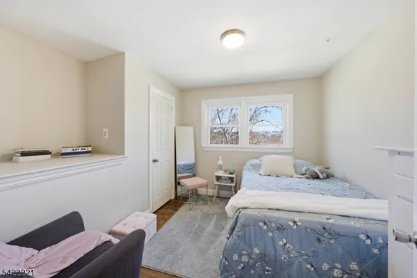 a bed room with furniture and wooden floor