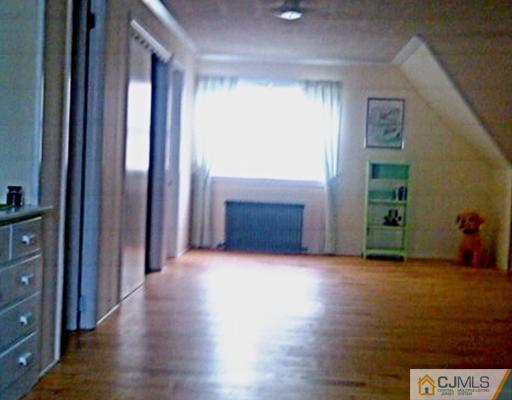 19 Old Post Road Edison, NJ 08817 - Photo 13 of 22 an empty room with wooden floor and windows