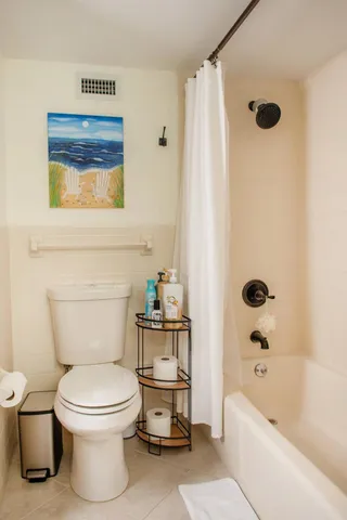 a bathroom with a toilet bathtub and shower