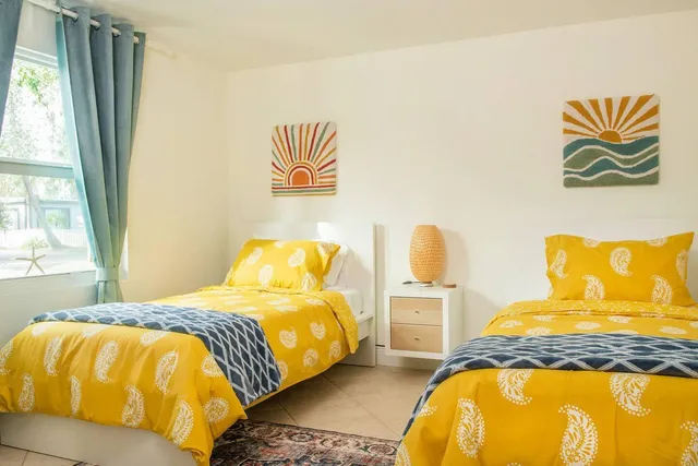 a bedroom with a bed and a painting on the wall