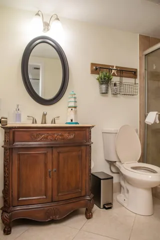 a bathroom with a toilet a sink and a mirror