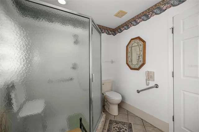 a bathroom with a toilet and a shower